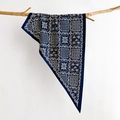 Detail of navy silk scarf with geometric floral print draped on a natural wooden branch - 88*136*64cm / Navy Blue