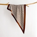 Silk-like geometric diamond print scarf draped on a branch for a minimalist style - Caramel Brown