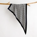 Minimalist black and white diamond print silk scarf hanging on a natural wooden branch - White