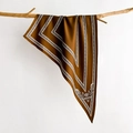 Elegant brown silk scarf with baroque patterns hanging on a natural wooden branch - Caramel Brown