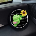 Cute green cartoon frog car air vent clip holding a yellow sunflower accessory - Floating Frog Style (2614D)