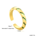 Detail view of gold twisted ring featuring green zircon stones and adjustable size specs - Gold Opening Twist Style with Green Zirconia (RI1710J7G)