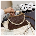Brown pleated shell bag with metal handle, pearl chain, and slender shoulder strap - Brown