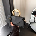 Elegant black handbag with crocodile pattern flap and unique gold metal handle - Black