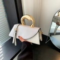 White crocodile pattern handbag featuring a unique golden fluid-style metal handle - White