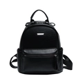 Close-up of litchi grain PU leather texture and silver metal buckle on black backpack - Black