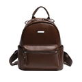 Detail of dark brown lychee texture PU leather backpack with silver metal plaque - Coffee