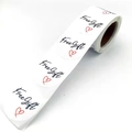 Roll of white Free Gift stickers with black script and red heart for gift labels - White