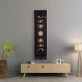 Bohemian floral moon phase tapestry with black fabric and decorative fringe hanging on a wall - Black Floral Moon Phase