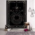 Detail view of a black and gold tarot tapestry hanging on a white brick wall in a cozy room - Style 15