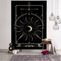 Black and gold tarot tapestry with sun and moon designs hanging on a white brick wall - Style 5