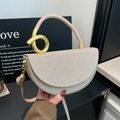 Champagne gold glitter saddle bag with a unique gold knot handle and turn-lock closure - Gold