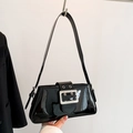 Retro black patent leather underarm bag featuring a large silver buckle and rivets - Black