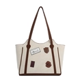 Große beige Tragetasche mit Retro-Aufnähern und kontrastierenden braunen Henkeln - Gebrochenes Weiß
