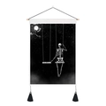 Detail of skull on swing tapestry featuring black tassels and a wooden hanging rod - 35x50cm
