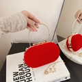 Elegante hellrote Samt-Abendtasche mit goldenem Rundgriff und Schleifenverschluss - Rot