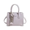 Lavender square shoulder bag with vertical stripe embossing and fashion strap detail - Purple