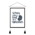 Detail of canvas wall hanging featuring literary quote and decorative black tassels - 35x50cm / Women who read are DANGEROUS (Style 12)