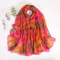 Flat lay of floral scarf with pink and orange patterns next to a simple magazine - Rose Pink