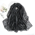 Close-up of black voile scarf with white polka dots draped elegantly on a white base - 180x85cm / Black