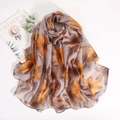 Detail of floral printed scarf showing soft drape texture and orange flower patterns - Light Gray