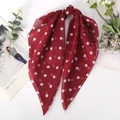 Red retro polka dot chiffon scarf tied in a bow with elegant floral background - Burgundy