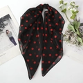 Lightweight black chiffon scarf with red polka dot pattern displayed on white surface - Black