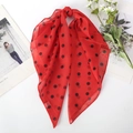 Detail of red polka dot chiffon scarf with soft drape and delicate floral decoration - Red