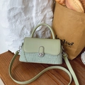 Mint green textured faux leather and straw patchwork handbag with a silver metal clasp - Green