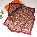 Detail of a square silk leopard print scarf with red borders and luxury gift box packaging - Leopard Wine Red