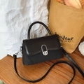 Elegant black textured crossbody bag with silver twist lock and leather flap detail - Black
