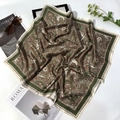Elegant paisley silk scarf with green and brown patterns displayed with fashion accessories - Army Green