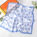 Detailed view of the 70cm square silk scarf with blue seashell print and border - Big Shell Blue