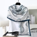Detail of blue and white paisley print satin scarf draped over a casual white T-shirt - 180x90cm / Navy Blue