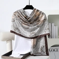 Detail of elegant paisley satin scarf with silky texture and vintage floral print patterns - 180x90cm / Brown