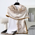 Detail view of paisley pattern silk scarf with golden chains on elegant white fabric - 180x90cm / Khaki