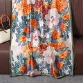 Close-up of floral silk scarf with large peonies and dark green rolled edges - Pink Orange