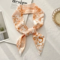 Detail of white and orange floral twilly silk scarf with hand-drawn lion print and S logo - Letter S (White Base Orange Lion Butterfly)