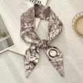 Detailed close-up of a French retro toile de jouy print silk ribbon scarf with tapered ends - Letter Q (Off-white Dark Brown Pastoral)