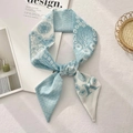 Detail of light blue floral silk scarf with letter K print on a soft texture background - Letter K (White Base Light Blue Floral)