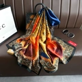 Close-up of printed silk scarf draped on a leather bag with premium pearl sunglasses - Blue