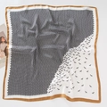 Flat lay of square satin scarf with abstract black pony print and gold border - 70x70cm / Multicolor Coffee Edge