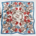Detailed top view of a soft floral print silk scarf featuring elegant blue borders - Flower Garland