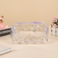 Macro view of clear PVC pouch with purple zipper and gold-edged clover prints - Clover (Purple)