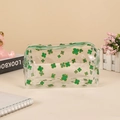 Macro shot of waterproof PVC pouch featuring green clover prints and a secure zipper top - Clover (Green)