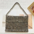 Detail shot of hand-woven dark grey metallic beads texture on a rectangular tote bag - Gray