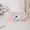 Detail view of rainbow gradient pencil case with yellow zipper and cute dog emblem - Yellow