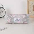 Close-up of cream bear mesh pencil case with heart patterns and soft fabric texture - Pink