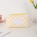 Detailed view of yellow checkerboard stationery pouch with Sweet Girl label and canvas texture - Yellow