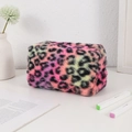 Detailed close-up of colorful leopard print plush makeup bag with soft faux fur texture - Rose Red